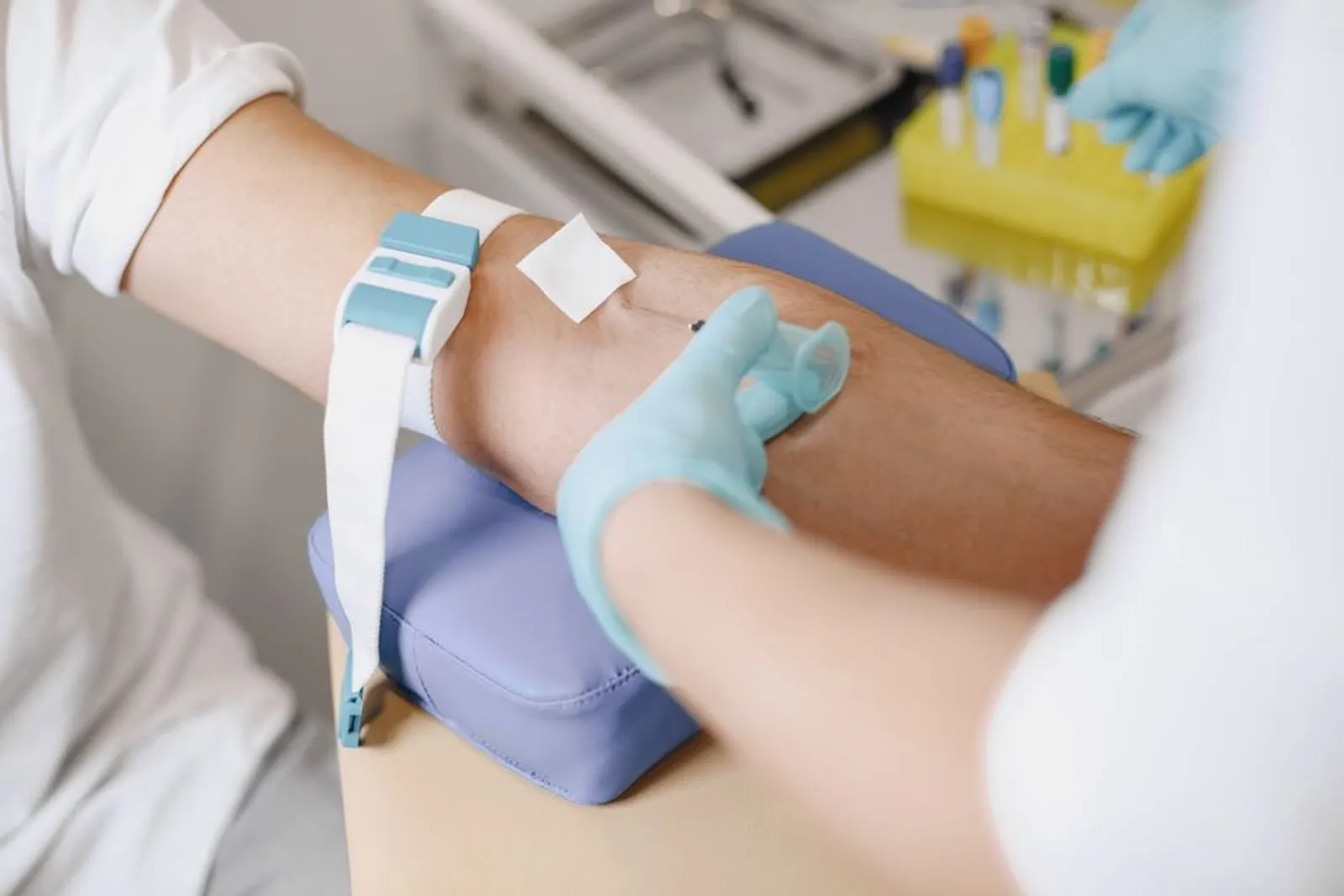A Tora partner clinician taking a blood sample at a collection centre