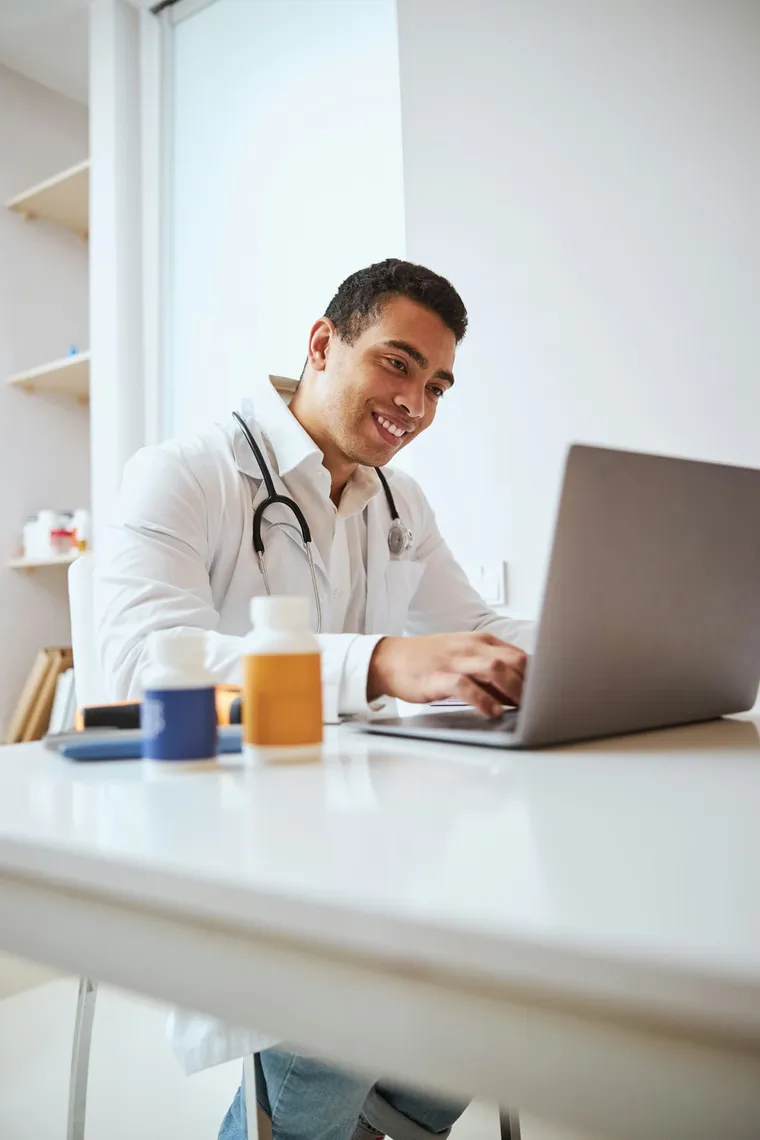 A qualified Australian doctor consulting on a laptop